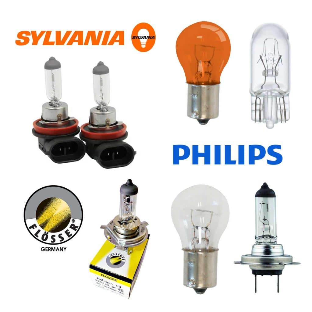 Bulk display of wholesale automotive light bulbs from USA Auto Supply in clear and amber, featuring high-end Flösser bulbs, Philips, and Sylvania miniature bulbs showing different connector types including wedge bases, single and double contact bayonet bases, and halogen socket configurations.